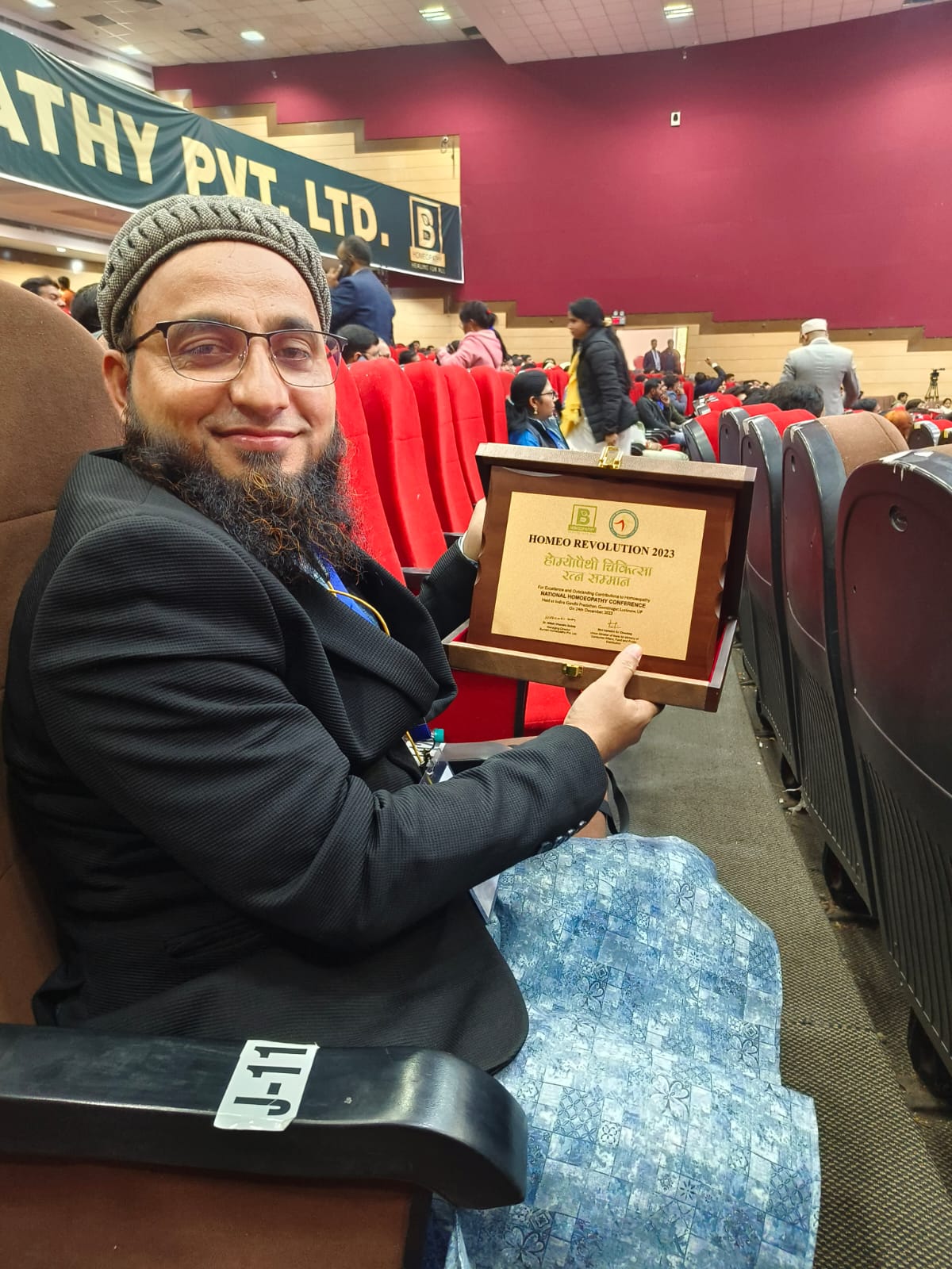 Dr. Taiyab Barbhuyan holding award